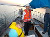 Lynn on the helm as we head for port, with Cyndy sketching