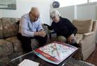 Sandra Atlin plays Scrabble with her husband Gordon, who has Alzheimer's disease, at their home in Toronto on Friday, Oct. 11, 2013.