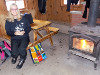 Kathryn warming by the fire in Huron